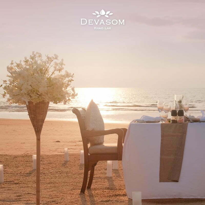 Private Valentine's dining on the beach surrounded by candles on the sand.