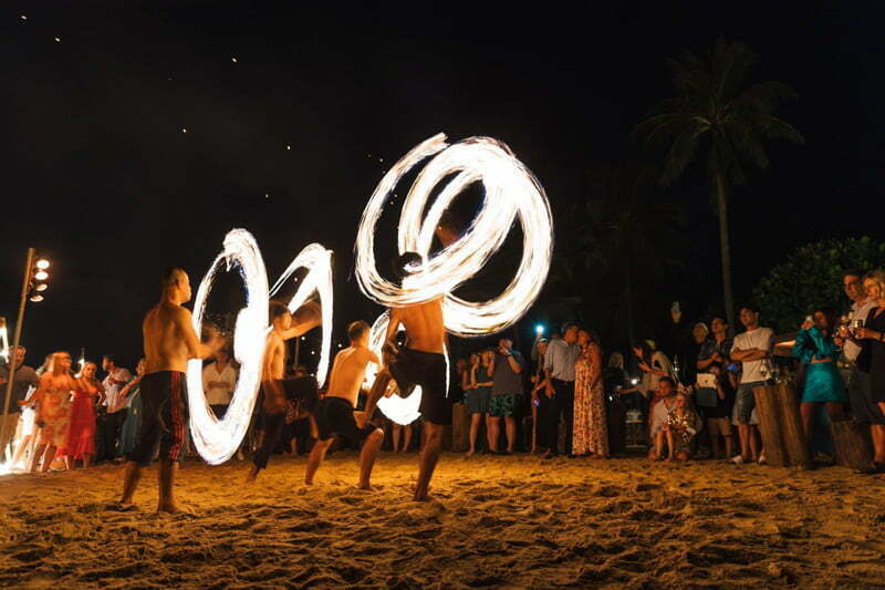 Exciting fire show with daring fire dances and stunts on the beach.
